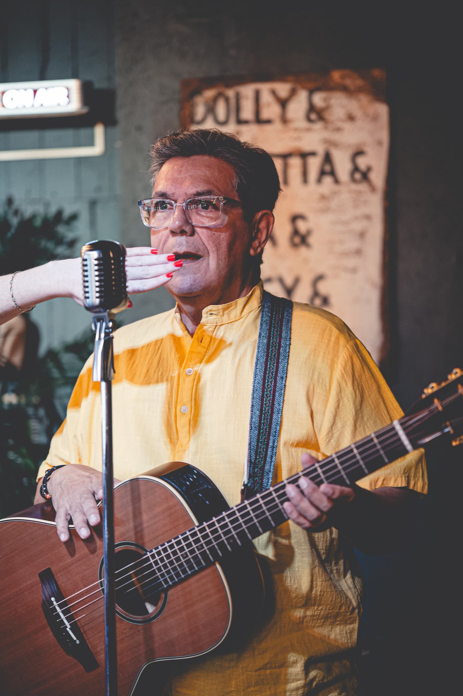 Blacky V performing with a hand over his mouth